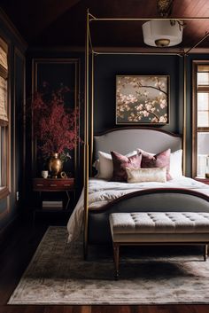 a bedroom with a canopy bed and paintings on the wall, along with a rug