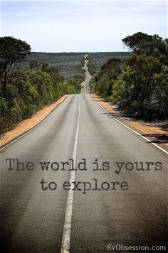 an empty road with the words the world is yours to explore