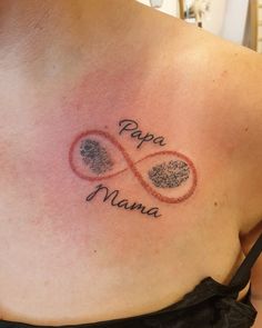 a woman with a tattoo on her chest that says papa mama and two finger prints