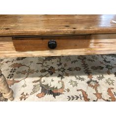 an old wooden table with two drawers on the bottom and one drawer at the top