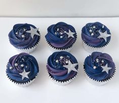 six cupcakes with blue frosting and stars on them