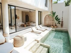 an indoor swimming pool with lounge chairs next to it