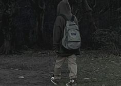 a person with a backpack walking in the woods