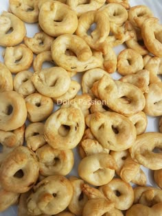 a pile of doughnuts sitting on top of a white plate next to each other