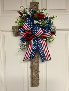 a patriotic wreath hanging on the front door