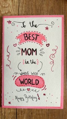 a card with the words, best mom in the world on it and pink ribbon