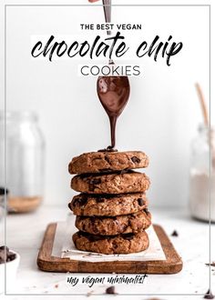 the best vegan chocolate chip cookies are stacked on top of each other and being drizzled with chocolate