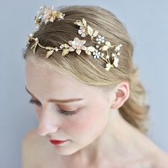 a woman wearing a gold head piece with flowers on it