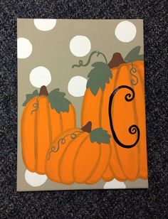 an acrylic painting of pumpkins with the letter c on it's side