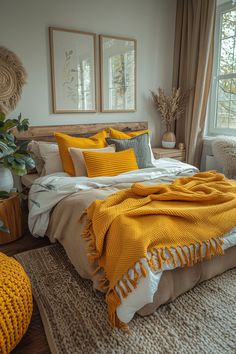 a bed with yellow blankets and pillows in a bedroom next to a window on a rug