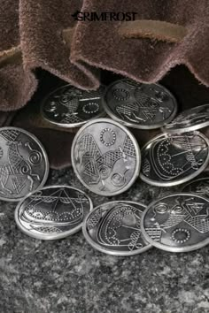 some silver coins sitting on top of a counter next to a pile of brown towels