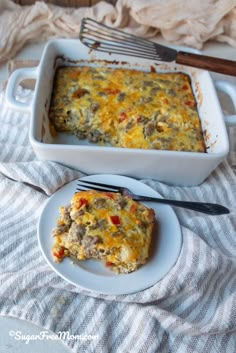 a casserole dish on a plate with a fork next to the casserole