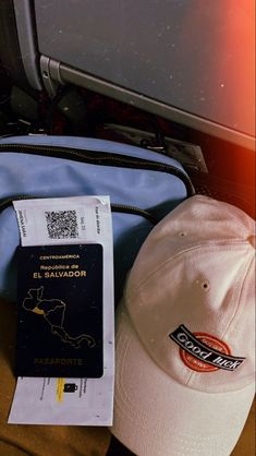 there is a passport, hat and bag on the ground