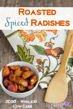 roasted spiced radishes in a bowl with a wooden spoon on the side