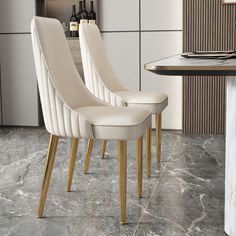 two white chairs sitting next to each other on top of a marble floored dining room table