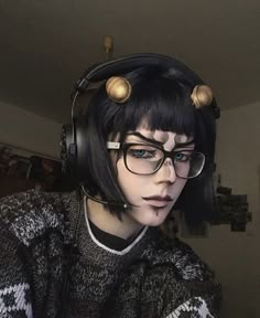 a woman wearing headphones and glasses with hair in the shape of birds on her head