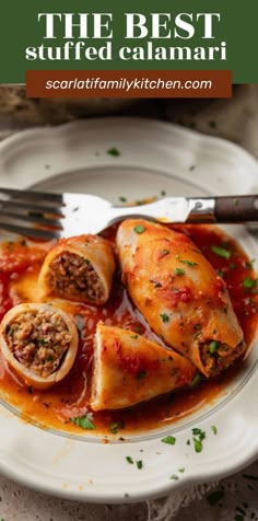 the best stuffed calamari recipe on a white plate with a fork and knife