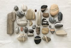 various rocks arranged in the shape of a heart on a white towel with black and gray stripes