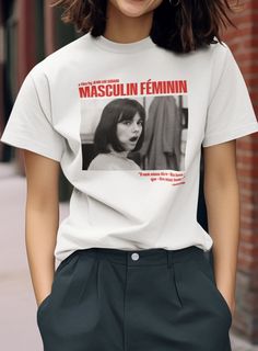 a woman wearing a white t - shirt with an image of a woman's face on it