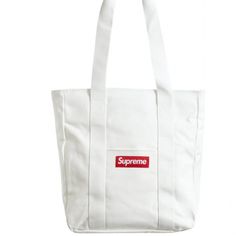 Supreme Canvas Tote Bag White Red New Fw20 Original Plastic Bag Luxury White Shoulder Bag With Large Capacity, White Luxury Large Capacity Shoulder Bag, Luxury White Large Capacity Shoulder Bag, Luxury Large Capacity White Shoulder Bag, Luxury White Canvas Bag With Top Carry Handle, Logo Tote Bag For Shopping, Large Capacity White Canvas Satchel Bag, Large Capacity White Canvas Satchel, White Canvas Satchel Shoulder Bag