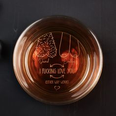 a glass bowl that has some writing on the inside of it and an image of two women's legs