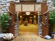 an entrance to a restaurant with tables and chairs