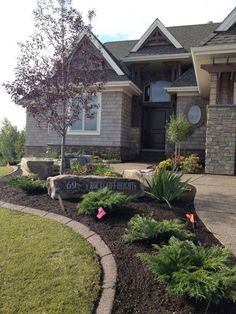 a house with landscaping in front of it and a sign that says go out there