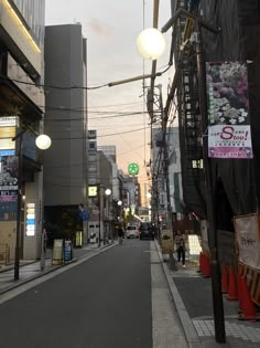 an empty city street with buildings and signs