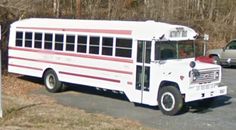 a white and red school bus parked in a parking lot