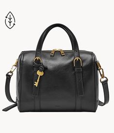 a black handbag with gold hardwares on the handles and shoulder strap, sitting next to a white background