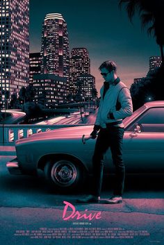 a man standing next to a car in front of a city at night with the words drive written on it