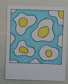 an image of eggs in the middle of a blue and yellow pattern on white paper