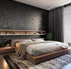 a large bed sitting in the middle of a bedroom next to a wall mounted shelf