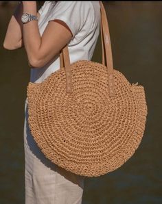 Introducing our Round Straw Bag - the epitome of boho chic and beach vibes. This rattan beach tote bag, also known as the Bali Bag, is the perfect accessory to elevate your style and bring a touch of bohemian charm to any outfit. Shape and Style: The bag's round shape adds a unique and trendy element to your look, making it a standout piece wherever you go. Its boho-inspired design is perfect for beach days, vacations, or casual outings, giving you that relaxed and carefree feel. Versatile Shoul Chic Beach Bag Made Of Natural Fiber, Chic Summer Bags Made Of Natural Fiber, Bohemian Beach Bag In Natural Fiber For Vacation, Bohemian Summer Straw Bag With Double Handle, Bohemian Summer Straw Tote Bag, Bohemian Double Handle Straw Bag For Summer, Bohemian Beach Bag For Everyday Spring Use, Bohemian Summer Bags In Natural Color, Spring Travel Beach Bag Made Of Rattan