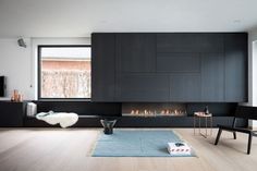 a living room filled with furniture and a fire place next to a wall mounted tv