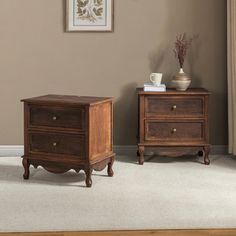 two wooden nightstands sitting next to each other on top of a carpeted floor