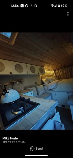 a kitchen with a stove top oven sitting next to a bed in a room filled with furniture