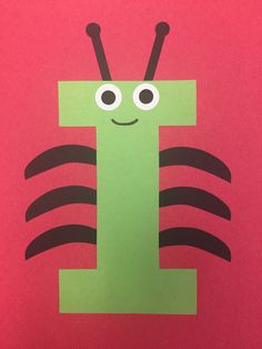 the letter e is made out of construction paper with eyes and antennae on it's body