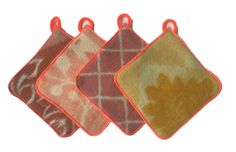 three orange and brown pot holders with leaves on them