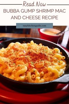 a skillet filled with macaroni and cheese on top of a red plate