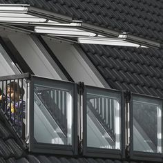 two people standing on the balcony of a building