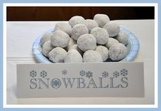 there is a plate full of snowballs on top of a table with a name sign