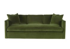 a green velvet couch with pillows on the top and bottom, in front of a white background