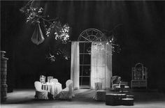 a black and white photo of a dining room