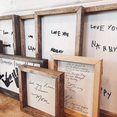 three wooden frames with writing on them sitting next to each other