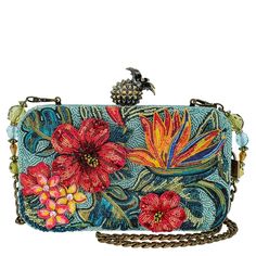 This vibrant handbag is a tropical escape in the form of a beaded accessory, featuring bursts of red and orange flowers blooming against a teal backdrop. The antique looking pineapple clasp adds a customized touch to its island-inspired allure.Product Details 8" x 2" x 5" Strap Length End to End: 46" Strap Drop: 21" Removable chain strap, clasp closure, inside pocket, metal logo fob, protective storage bag, certificate of authenticity, fits a phone This is a handmade item, each one an individual Teal Backdrop, Red And Orange Flowers, Mary Frances Bags, Novelty Handbags, Novelty Purses, Mary Frances, Flowers Blooming, Tropical Escape, Paradise Found