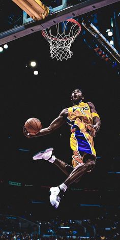 a basketball player jumping up into the air to dunk a ball in front of him