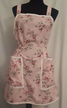 the apron is pink with flowers on it