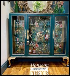 an old china cabinet painted in teal and gold