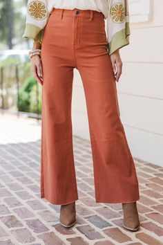 These wide leg, crop jeans are so cute! We love that bold rust coloring and no distressing other than those raw hems. These jeans are going to be a great addition to your wardrobe! Button/zip front closure High waist Pockets Wide legs Cropped... Black Tie Dress, Long Sleeve Outerwear, Cute Rompers, Sweater Tank Top, Rust Orange, Crop Jeans, Model Fits, Girl Sweatshirts, Shoes With Jeans